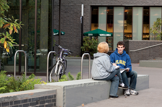 student in front of bookstore