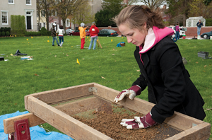 Student sifting through dirt