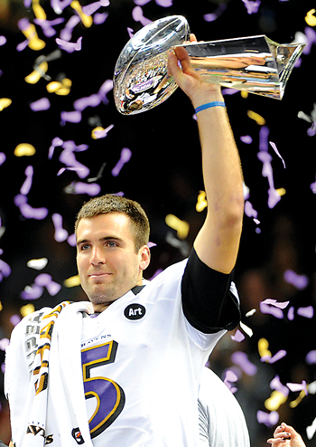 Joe Flacco holding superbowl trophy after game