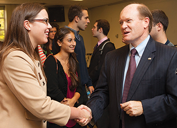 U.S. Sen. Chris Coons greets Jessica Borcky, UD Student Government Association president.