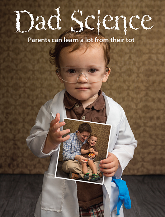 Ben Gallagher holds a photo of his dad, Shaun, doing an experiment with him.