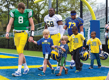 Football players with young fans