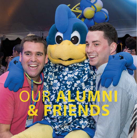 Alumni title page-image of two alumni with YoUDee at Alumni weekend