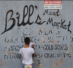 A woman fills out a study against a painted wall in Wilmington