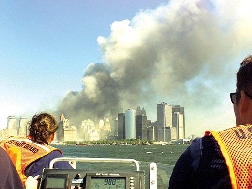 image of Twin Towers smoking in NYC from boat in harbor on 9/11