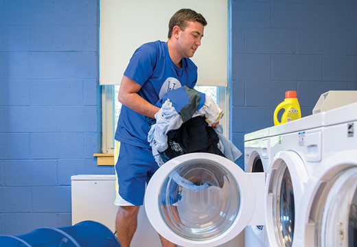 Image of Nick Godwin doing his laundry