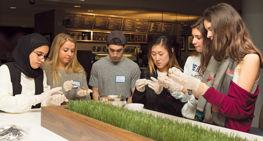 Image of students in the World Kitchn program cooking together